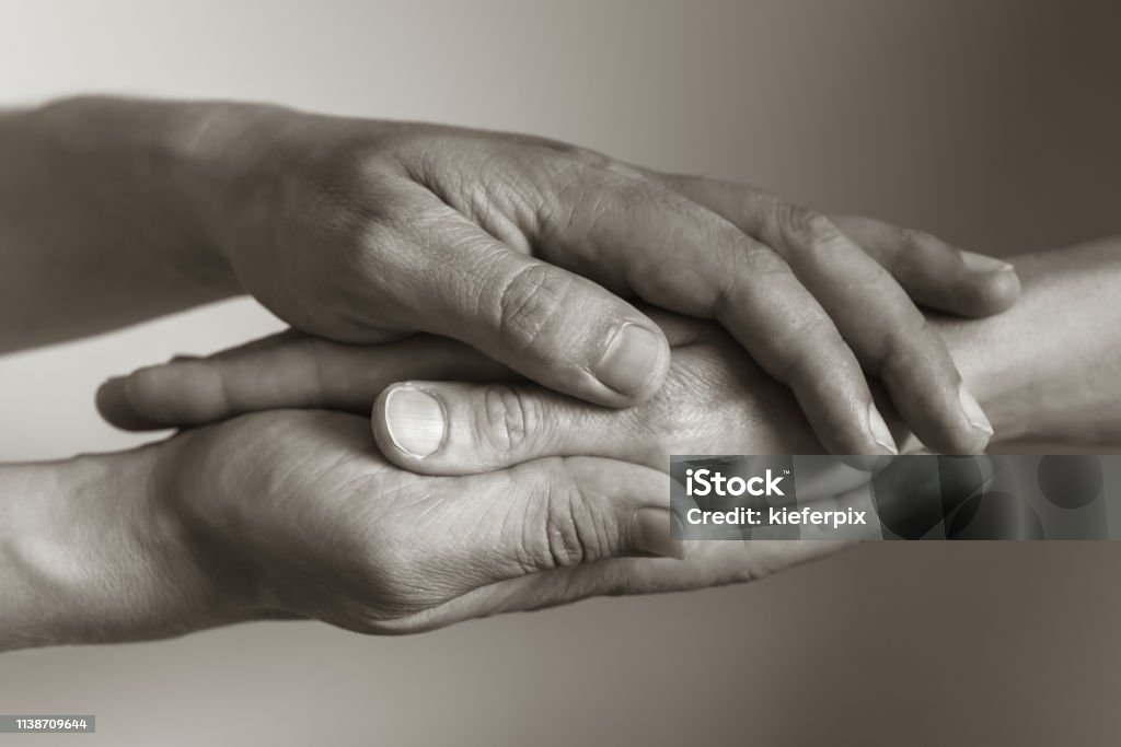 Let me help you Hand holding another hand. Help and understanding concept. Mourning Stock Photo