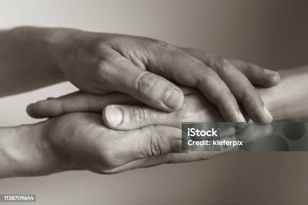Let Me Help You Stock Photo - Download Image Now - Mourning, Holding Hands, Consoling