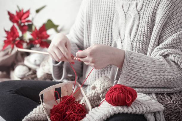 istock woman knits knitting needles on the couch 1138709927