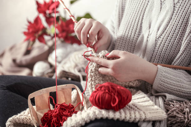 istock woman knits knitting needles on the couch 1138709933