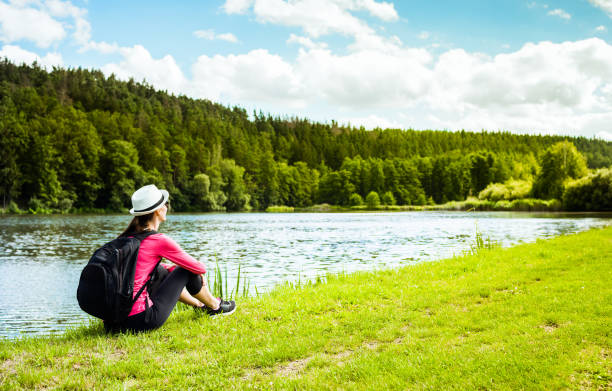 istock Woman relaxing by the river 1138710324