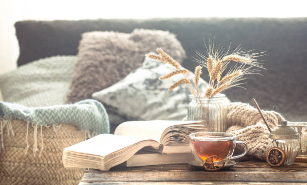 Still life details of home interior on a wooden table with a Cup of tea Still life details of home interior on a wooden table with a Cup of tea, the concept of coziness and home atmosphere .Living room hygge photos stock pictures, royalty-free photos & images