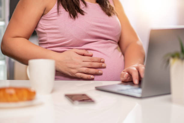 istock Pregnant woman using laptop 1138711609