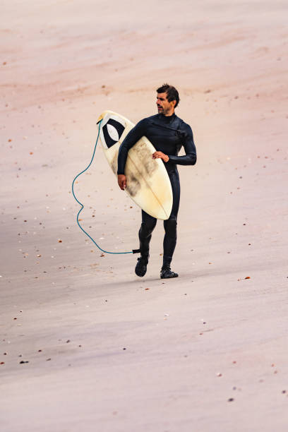 istock Male surfer wearing wetsuit 1138715614