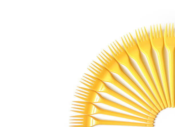 istock Plastic yellow forks on a white background. Selective focus, top view. 1138716049