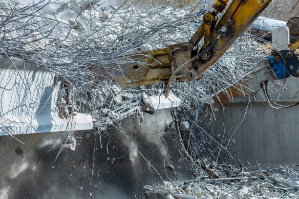 istock Professional demolition of reinforced concrete structures using industrial hydraulic hammer. Rods of metal fittings. Wreckage and crumbles of concrete. 1138716066