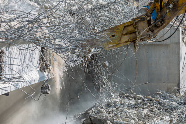 istock Professional demolition of reinforced concrete structures using industrial hydraulic hammer. Rods of metal fittings. Wreckage and crumbles of concrete. 1138716078