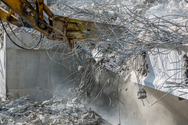 istock Professional demolition of reinforced concrete structures using industrial hydraulic hammer. Rods of metal fittings. Wreckage and crumbles of concrete. 1138716094
