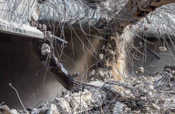 istock Professional demolition of reinforced concrete structures using industrial hydraulic hammer. Rods of metal fittings. Wreckage and crumbles of concrete. 1138716095