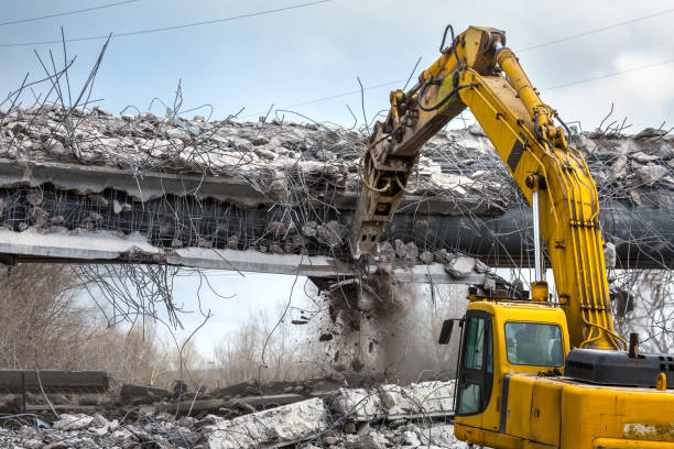 istock Professional demolition of reinforced concrete structures using industrial hydraulic hammer. Rods of metal fittings. Wreckage and crumbles of concrete. 1138716096
