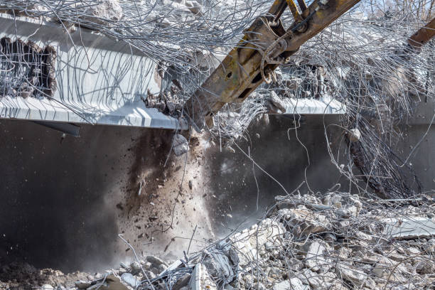 istock Professional demolition of reinforced concrete structures using industrial hydraulic hammer. Rods of metal fittings. Wreckage and crumbles of concrete. 1138716100