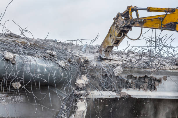 istock Professional demolition of reinforced concrete structures using industrial hydraulic hammer. Rods of metal fittings. Wreckage and crumbles of concrete. 1138716120