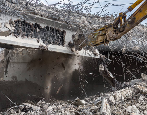 istock Professional demolition of reinforced concrete structures using industrial hydraulic hammer. Rods of metal fittings. Wreckage and crumbles of concrete. 1138716141