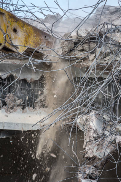 istock Professional demolition of reinforced concrete structures using industrial hydraulic hammer. Rods of metal fittings. Wreckage and crumbles of concrete. 1138716147
