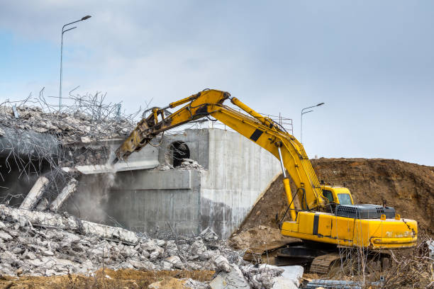 istock Professional demolition of reinforced concrete structures using industrial hydraulic hammer. Rods of metal fittings. Wreckage and crumbles of concrete. 1138716157