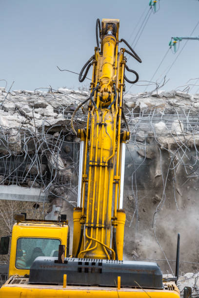 istock Professional demolition of reinforced concrete structures using industrial hydraulic hammer. Rods of metal fittings. Wreckage and crumbles of concrete. 1138716158
