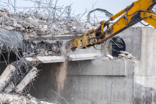 istock Professional demolition of reinforced concrete structures using industrial hydraulic hammer. Rods of metal fittings. Wreckage and crumbles of concrete. 1138716159