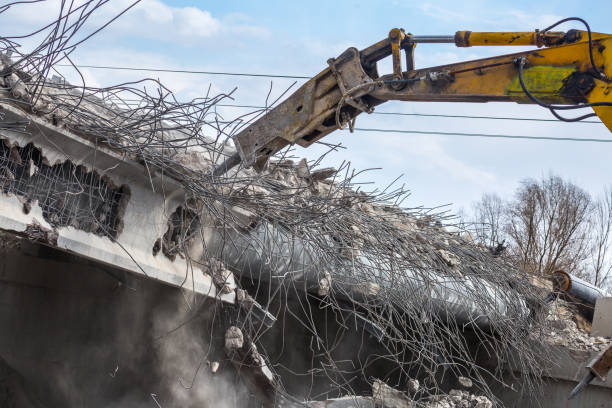 istock Professional demolition of reinforced concrete structures using industrial hydraulic hammer. Rods of metal fittings. Wreckage and crumbles of concrete. 1138716161