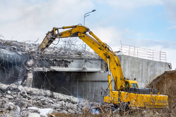istock Professional demolition of reinforced concrete structures using industrial hydraulic hammer. Rods of metal fittings. Wreckage and crumbles of concrete. 1138716169