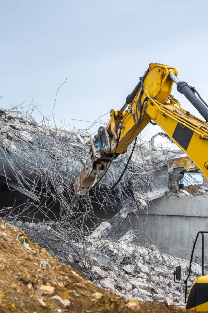 istock Professional demolition of reinforced concrete structures using industrial hydraulic hammer. Rods of metal fittings. Wreckage and crumbles of concrete. 1138716172
