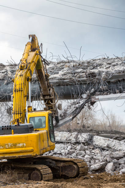 istock Professional demolition of reinforced concrete structures using industrial hydraulic hammer. Rods of metal fittings. Wreckage and crumbles of concrete. 1138716173