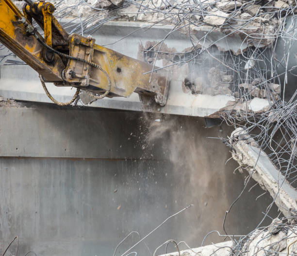 istock Professional demolition of reinforced concrete structures using industrial hydraulic hammer. Rods of metal fittings. Wreckage and crumbles of concrete. 1138716179