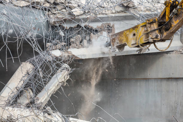 istock Professional demolition of reinforced concrete structures using industrial hydraulic hammer. Rods of metal fittings. Wreckage and crumbles of concrete. 1138716186
