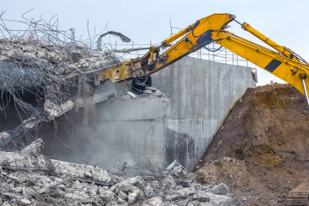 istock Professional demolition of reinforced concrete structures using industrial hydraulic hammer. Rods of metal fittings. Wreckage and crumbles of concrete. 1138716187