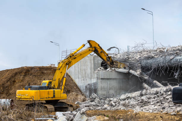 istock Professional demolition of reinforced concrete structures using industrial hydraulic hammer. Rods of metal fittings. Wreckage and crumbles of concrete. 1138716188