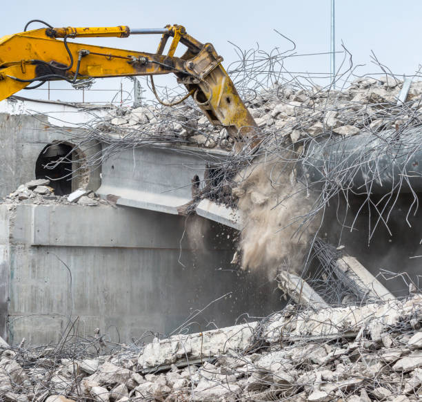 istock Professional demolition of reinforced concrete structures using industrial hydraulic hammer. Rods of metal fittings. Wreckage and crumbles of concrete. 1138716189