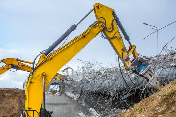 istock Professional demolition of reinforced concrete structures using industrial hydraulic hammer. Rods of metal fittings. Wreckage and crumbles of concrete. 1138716194