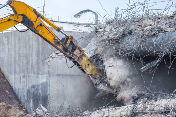 istock Professional demolition of reinforced concrete structures using industrial hydraulic hammer. Rods of metal fittings. Wreckage and crumbles of concrete. 1138716195