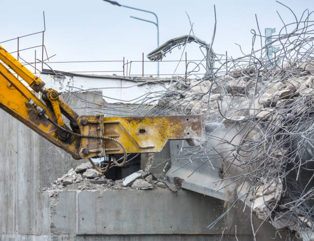 istock Professional demolition of reinforced concrete structures using industrial hydraulic hammer. Rods of metal fittings. Wreckage and crumbles of concrete. 1138716197