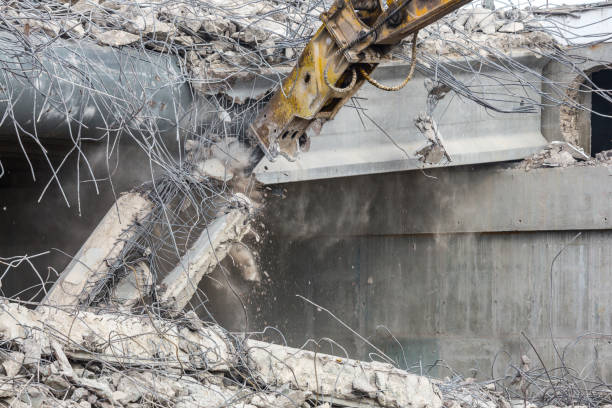 istock Professional demolition of reinforced concrete structures using industrial hydraulic hammer. Rods of metal fittings. Wreckage and crumbles of concrete. 1138716198