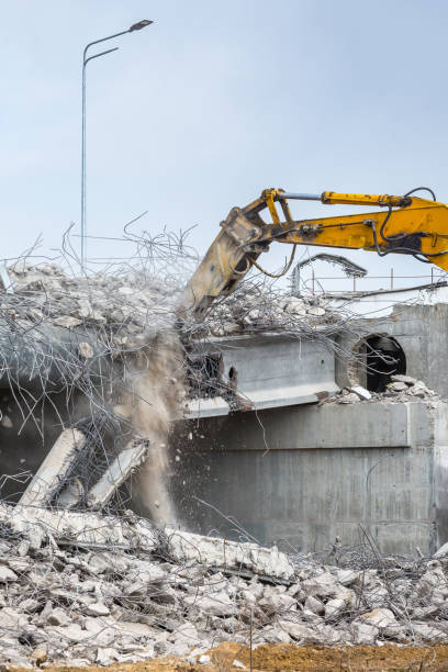 istock Professional demolition of reinforced concrete structures using industrial hydraulic hammer. Rods of metal fittings. Wreckage and crumbles of concrete. 1138716200