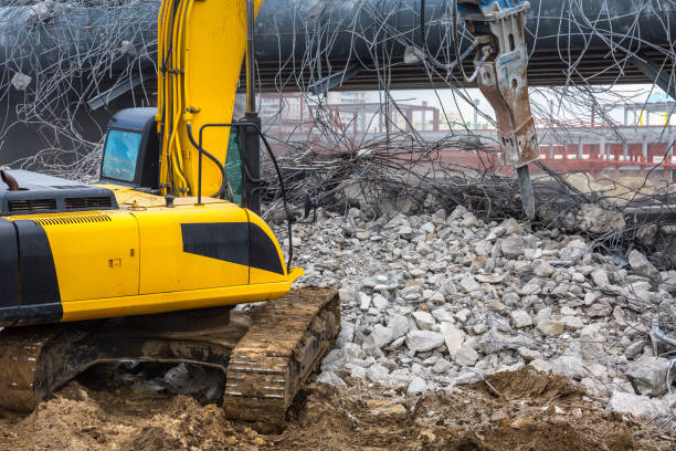 istock Professional demolition of reinforced concrete structures using industrial hydraulic hammer. Rods of metal fittings. Wreckage and crumbles of concrete. 1138716201