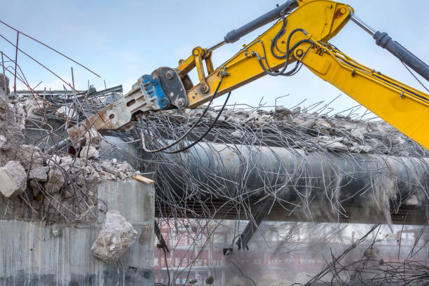 istock Professional demolition of reinforced concrete structures using industrial hydraulic hammer. Rods of metal fittings. Wreckage and crumbles of concrete. 1138716202