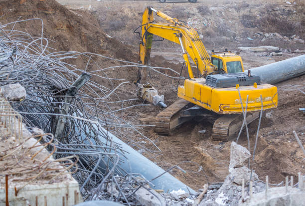 istock Professional demolition of reinforced concrete structures using industrial hydraulic hammer. Rods of metal fittings. Wreckage and crumbles of concrete. 1138716214