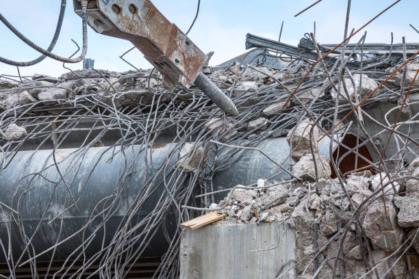istock Professional demolition of reinforced concrete structures using industrial hydraulic hammer. Rods of metal fittings. Wreckage and crumbles of concrete. 1138716218
