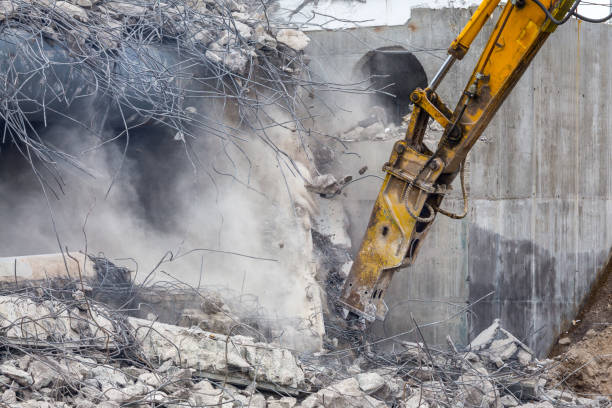 istock Professional demolition of reinforced concrete structures using industrial hydraulic hammer. Rods of metal fittings. Wreckage and crumbles of concrete. 1138716224