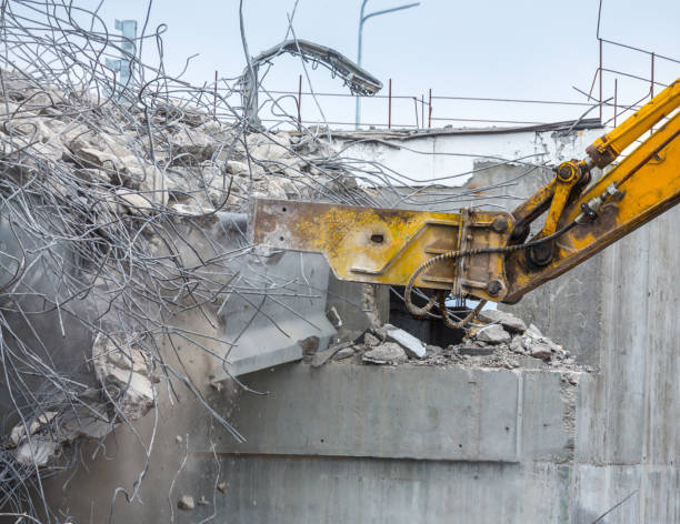 istock Professional demolition of reinforced concrete structures using industrial hydraulic hammer. Rods of metal fittings. Wreckage and crumbles of concrete. 1138716225