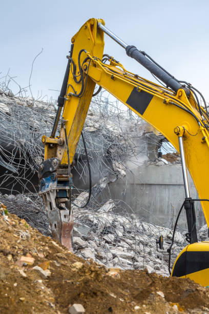 istock Professional demolition of reinforced concrete structures using industrial hydraulic hammer. Rods of metal fittings. Wreckage and crumbles of concrete. 1138716226