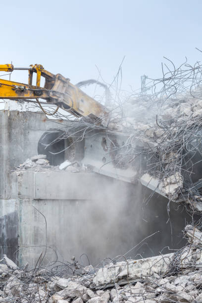 istock Professional demolition of reinforced concrete structures using industrial hydraulic hammer. Rods of metal fittings. Wreckage and crumbles of concrete. 1138716230