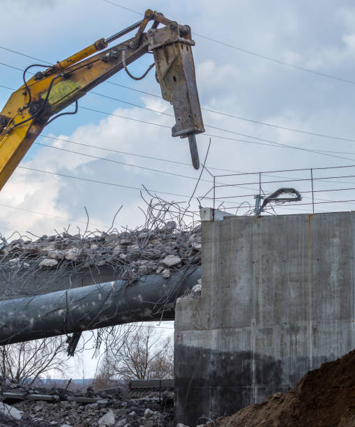 istock Professional demolition of reinforced concrete structures using industrial hydraulic hammer. Rods of metal fittings. Wreckage and crumbles of concrete. 1138716242