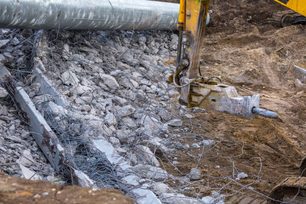 istock Professional demolition of reinforced concrete structures using industrial hydraulic hammer. Rods of metal fittings. Wreckage and crumbles of concrete. 1138716244