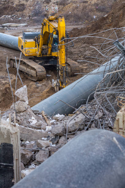 istock Professional demolition of reinforced concrete structures using industrial hydraulic hammer. Rods of metal fittings. Wreckage and crumbles of concrete. 1138716246