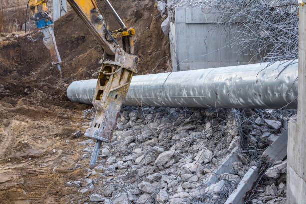istock Professional demolition of reinforced concrete structures using industrial hydraulic hammer. Rods of metal fittings. Wreckage and crumbles of concrete. 1138716247