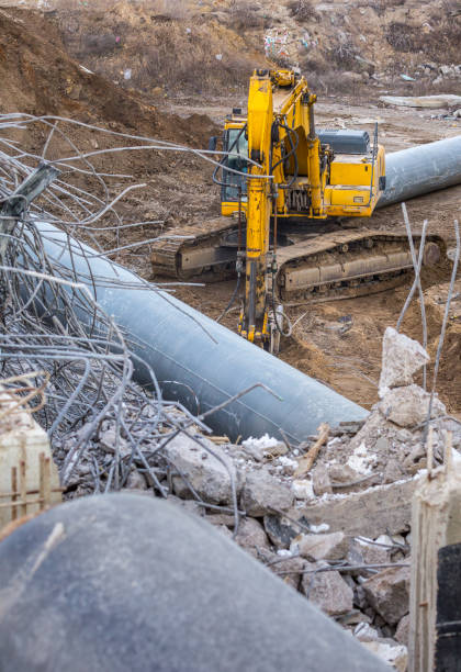 Professional demolition of reinforced concrete structures using industrial hydraulic hammer. Rods of metal fittings. Wreckage and crumbles of concrete. Professional demolition of reinforced concrete structures using industrial hydraulic hammer. Rods of metal fittings. Wreckage and crumbles of concrete. deconstruct stock pictures, royalty-free photos & images