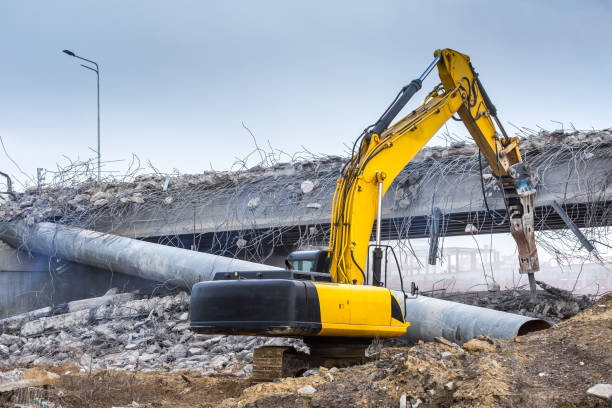 istock Professional demolition of reinforced concrete structures using industrial hydraulic hammer. Rods of metal fittings. Wreckage and crumbles of concrete. 1138716257