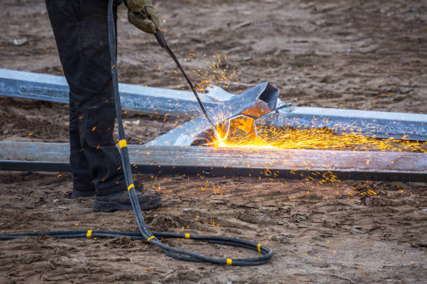 istock A worker cut steel beams using propane-oxygen torch.